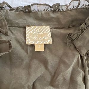 Women’s dress with ruffles around neck and gold belt. Light silky material